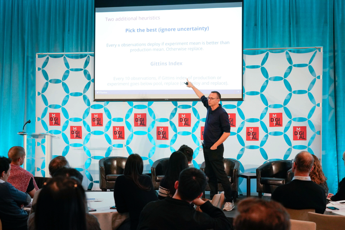 Man pointing at a large screen at CODE 2025 conference at MIT
