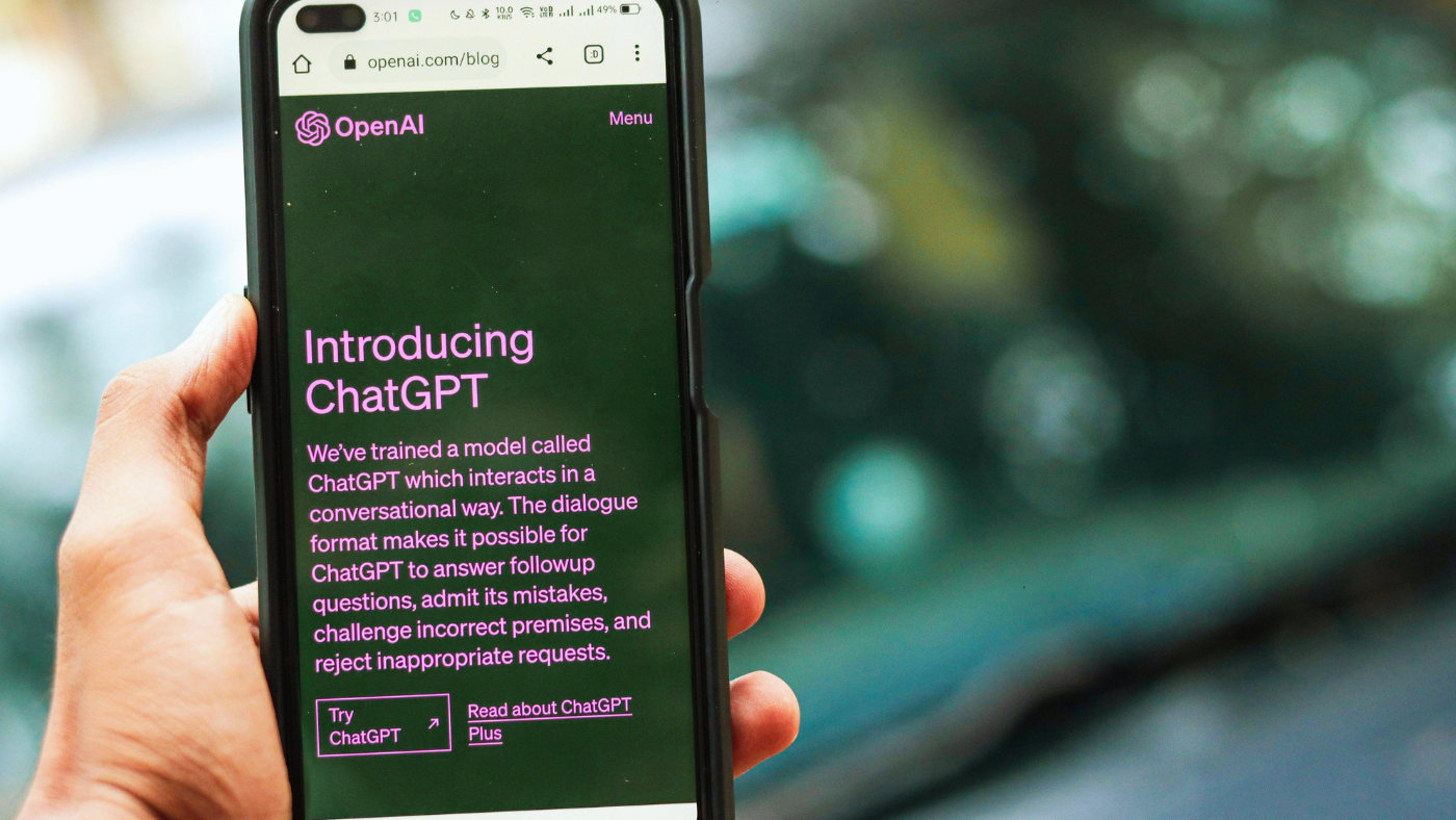 Hand holding a phone with ChatGPT on the screen