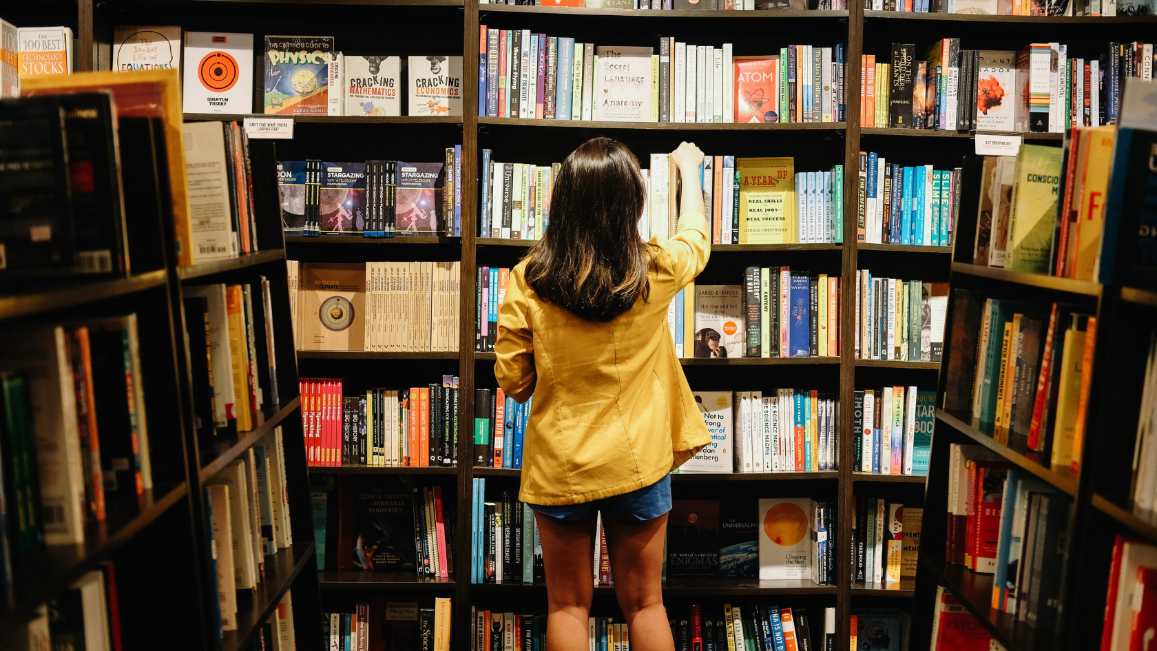 Woman looking at books on shelves in a bookstore